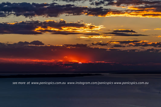 Sunset over a body of water with vibrant colors in the sky