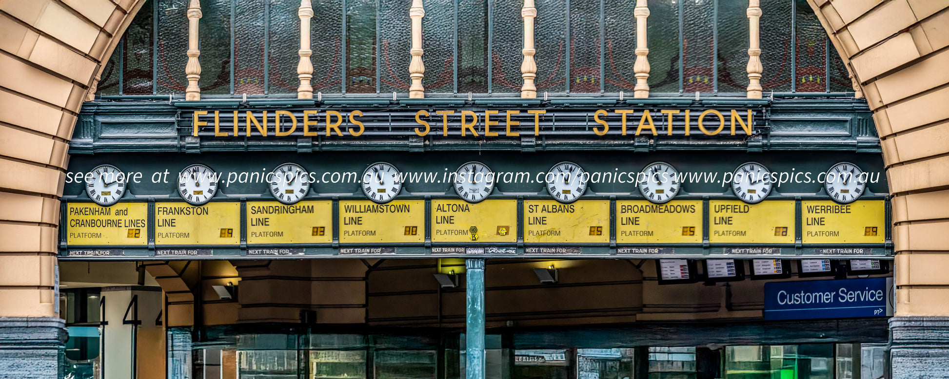 Flinders Street Station sign with decorative elements on a building facade.