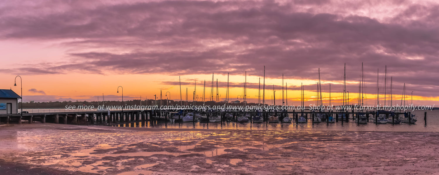 Marina at sunset with colorful sky and water reflection