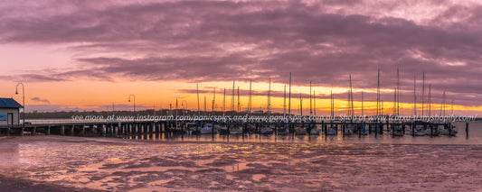 Marina at sunset with colorful sky and water reflection